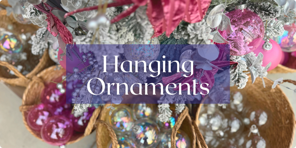 Many glittering tree ornaments are shown in a tree and in baskets below in shades of pink and silver. Text: Hanging Ornaments.